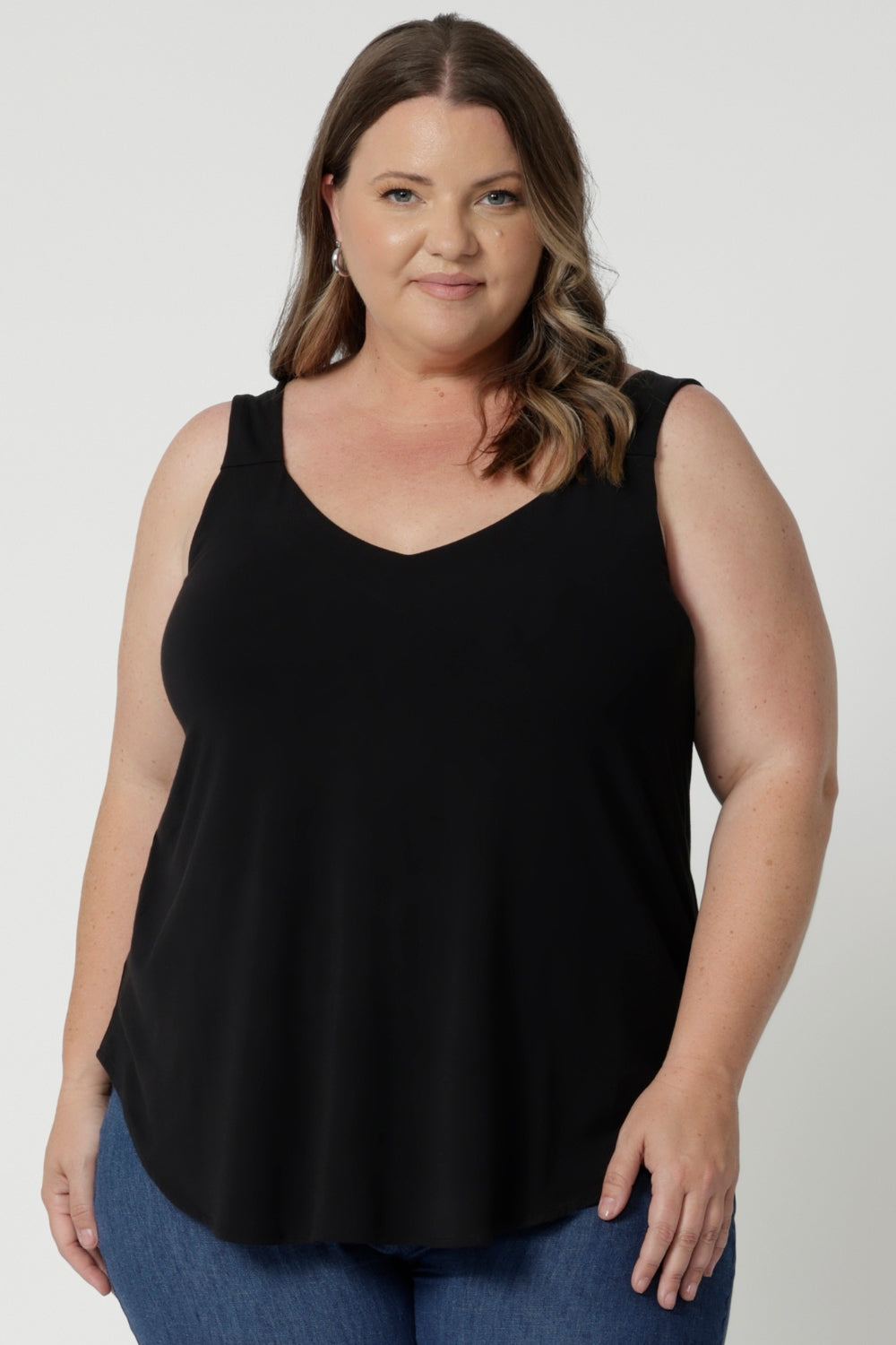 Plus sized model wears graphite coloured bamboo cami that is lightweight and breathable. Designed for all-day wear, combining practicality with timeless style. Whether layered or worn on its own, this cami ensures you stay cool, chic, and comfortable no matter where the day takes you. Leina & Fleur Stock this cami in sizes 8-24.