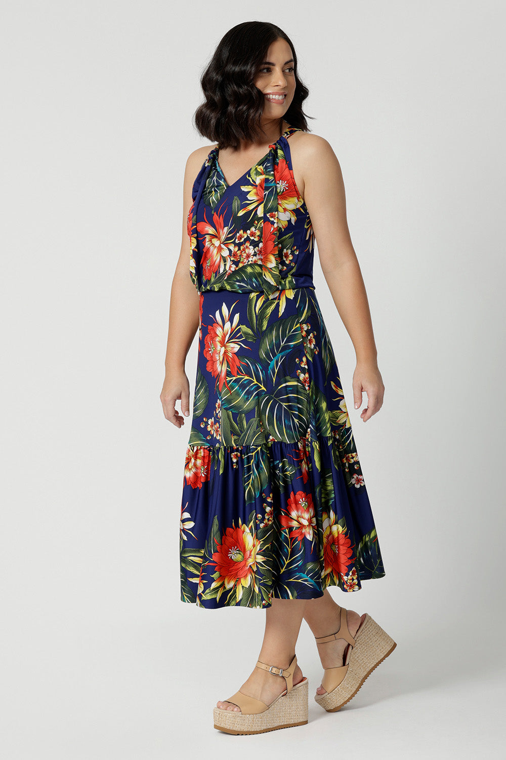 A midi floral dress for cruise holidays and resort style perfect for summer Easy care slinky jersey dress worn by petite woman shows length of dress. This floral jersey fabric is easy-care and crease-resistant. Australian made for Australian and New Zealand women. Fashion brand Leina & Fleur stock sizes in sizes 8 to 24. Shop easy travel pieces online.