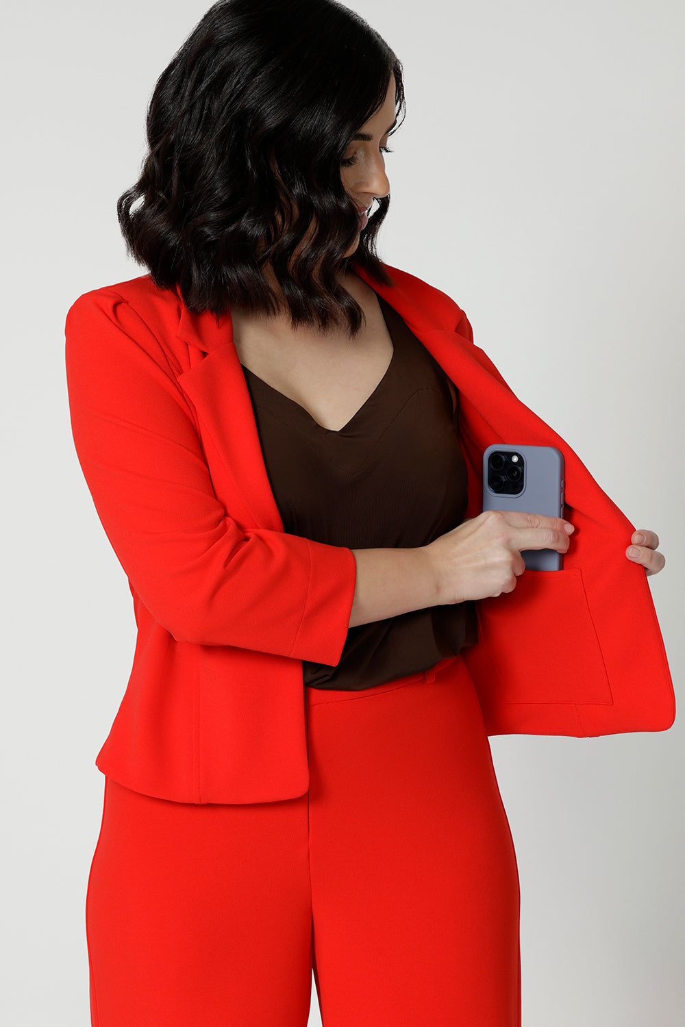 The double-layered tailored front panels add structure, while a hidden phone pocket on the inner left side ensures practicality without compromising the sleek aesthetic. Available in sizes 8-24.