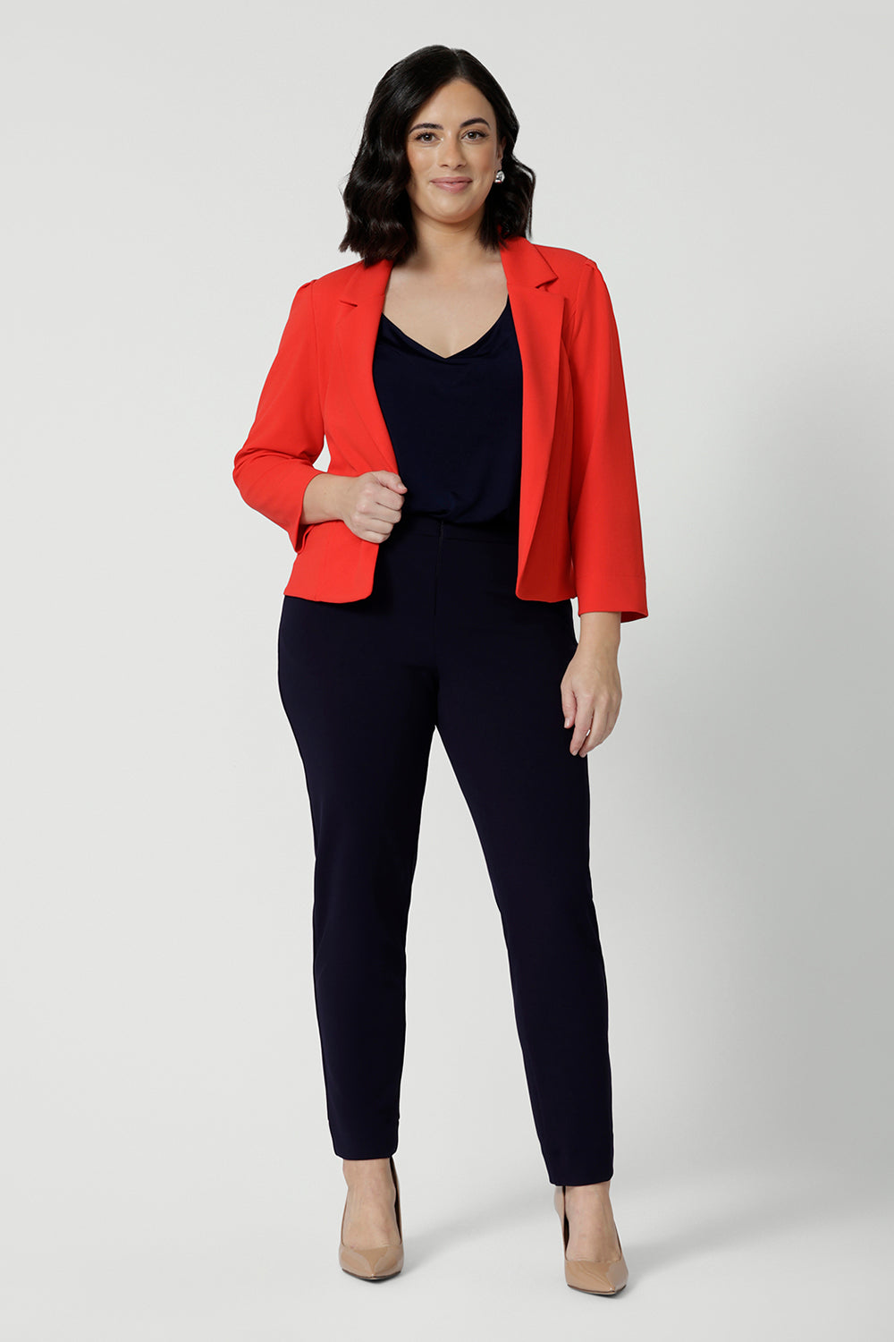 Made from luxe Scuba Crepe, the fabric has a soft, textured feel with just the right amount of stretch, providing both comfort and shape. Petite height model wears classic workwear black pants and top with a pop of colour with the Benni Jacket in Tangerine.