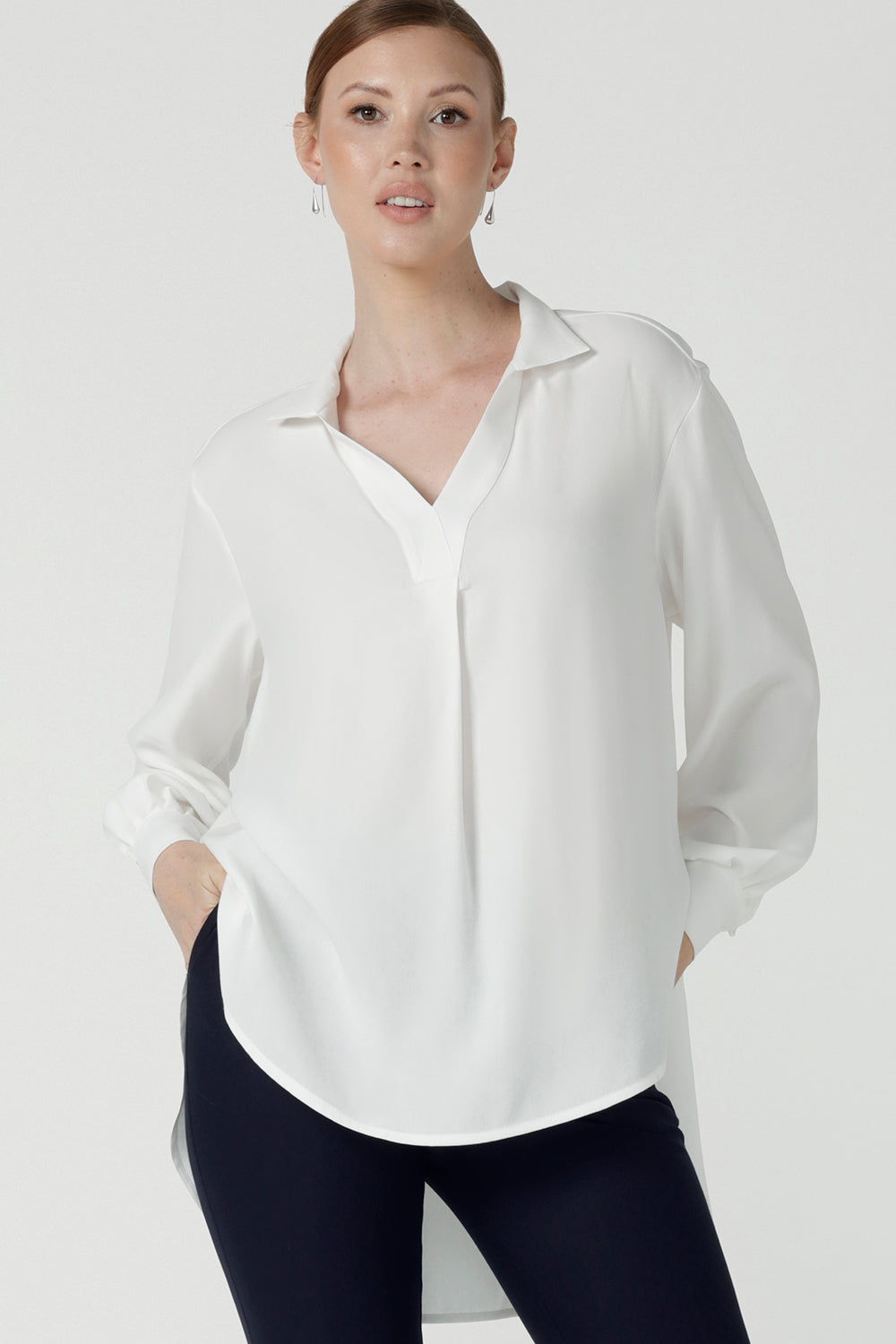 A size 10 woman wears the Ellis shirt in Vanilla tencel, a high quality made in Australia womens shirt made in breathable tencel. Inclusive size range 8-24 and made in Australia.