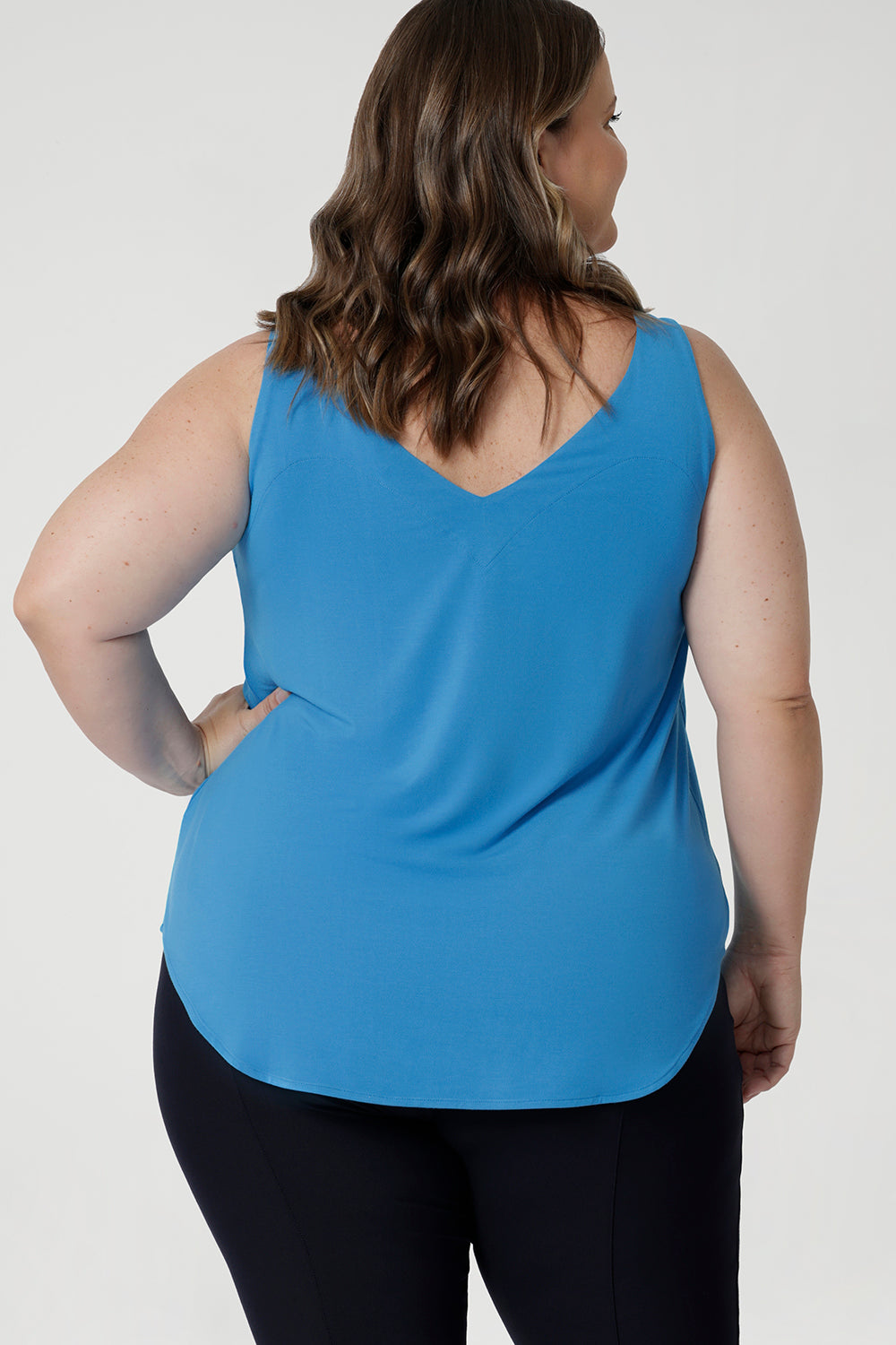 Size 18 woman wears summer ready cami in opal colour. Ideal choice for warm weather, offering a breezy and flattering fit. The top features a graceful V-neckline both in the front and the back, adding a touch of sophistication and subtle femininity to the overall look.