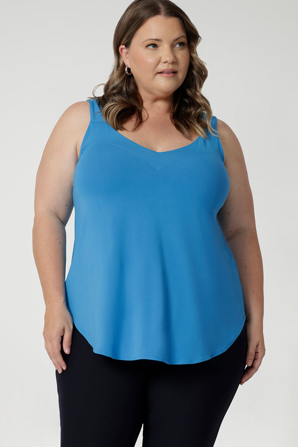 Plus Sized Model wears bamboo cami that is lightweight and breathable. Designed for all-day wear, combining practicality with timeless style. Whether layered or worn on its own, this cami ensures you stay cool, chic, and comfortable no matter where the day takes you. Leina & Fleur Stock this cami in sizes 8-24.