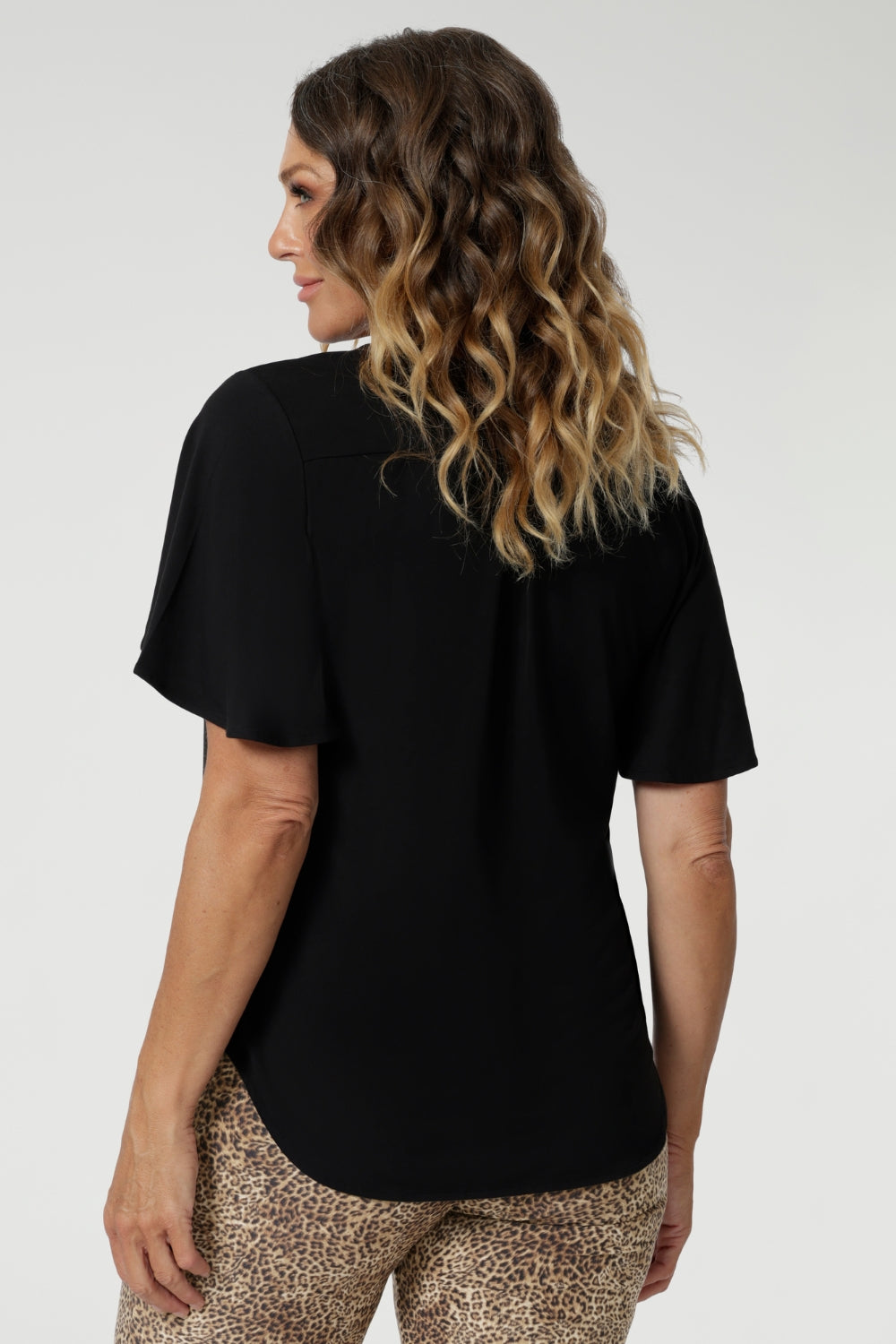 Size 12 model wears easy care bamboo top. Fabric has just the right amount of stretch to provide a comfortable fit that moves with you, making it ideal for all-day wear.