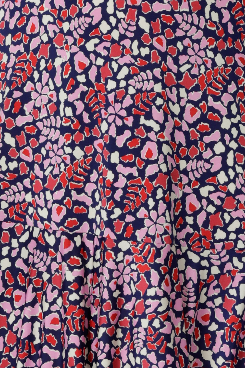 Fabric Swatch of a red, pink, and white abstract print on navy slinky jersey, used by Australian and New Zealand, women's fashion label, Leina & Fleur to make summer dresses and tops for women.