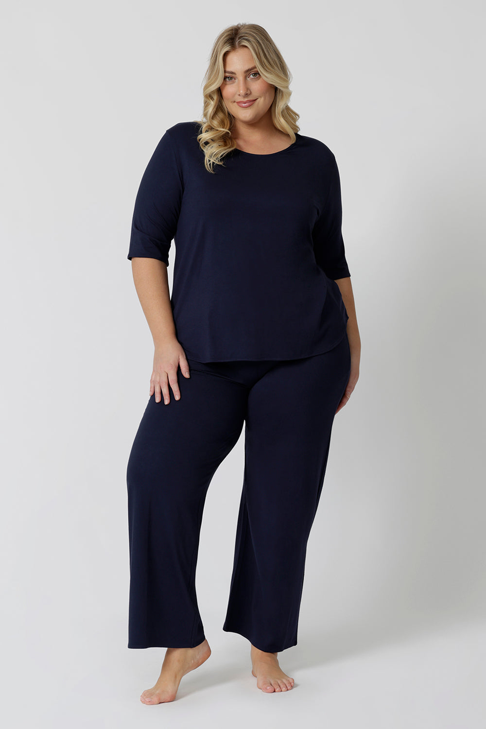 Showing good lounge pants for curvy women, a size 18 wears straight, wide leg navy blue, plus size lounge pants in bamboo jersey with a navy blue, slouchy tee top. Breathable and thermo-regulating this is a good pyjama set for night sweats and hot flushes. Stay cool for summer nights with breathable sleepwear by L&F Australia in sizes 8-24.