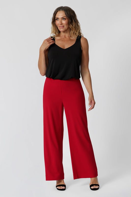 Good pants for over 40s women,  the Drew pant in red is a high waist pant with wide legs. Tailored belt loops and wide leg. Made in Australia for women. Stylish corporate wear for women. Made in Australia size 8 - 24. 