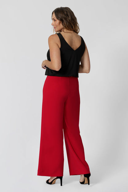 Back view of good pants for over 40s women,  the Drew pant in red is a high waist pant with wide legs. Tailored belt loops and wide leg. Made in Australia for women. Stylish corporate wear for women. Made in Australia size 8 - 24. 