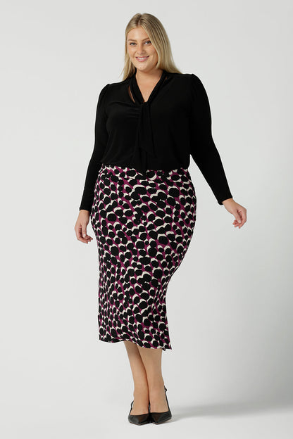 Andi Midi Skirt in Alula in a size 18 is a midi length skirt with the Alula print. Made in Australia style. Styled back with the Thom Top in black. - 24.