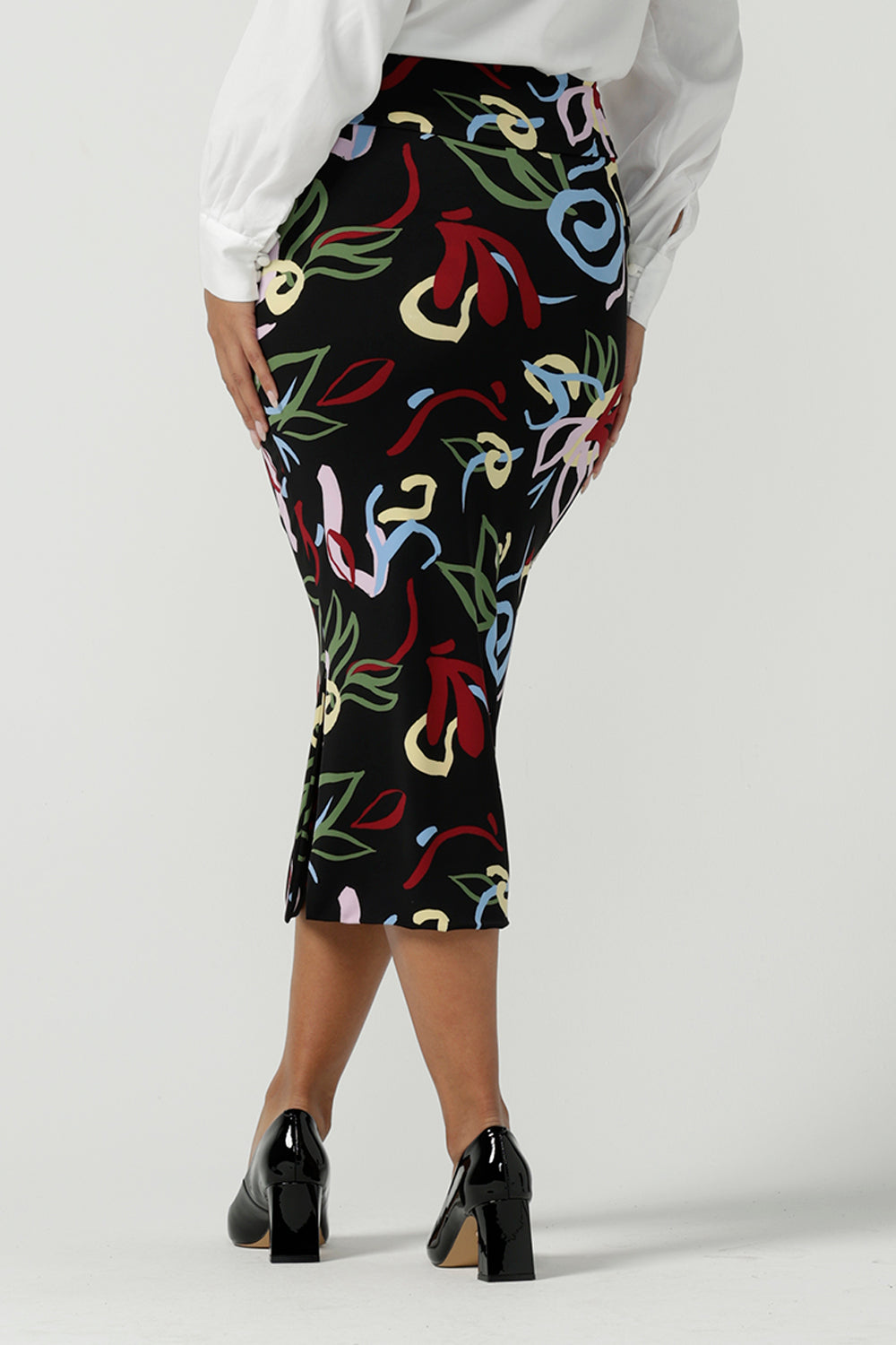 Back view of a size 10 woman wearing the Boronia Midi Skirt back with a white Tencel Matisse shirt with a tick neckline. Made in Australia for women size 8 - 24.