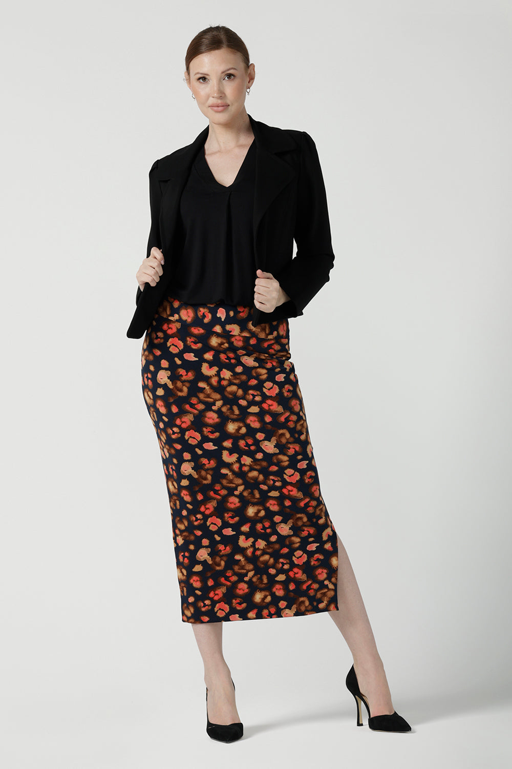 A size 10 woman is wearing the Andi Midi Tube skirt in Lava. A leopard print jersey print work skirt. Made in Australia for women size 8 - 24. 