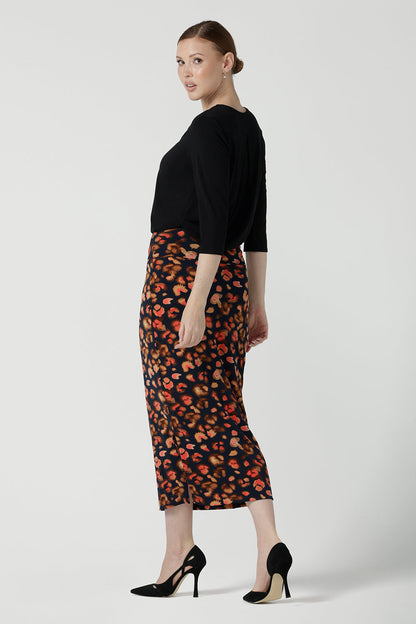 Back view of a size 10 woman is wearing the Andi Midi Tube skirt in Lava. A leopard print jersey print work skirt. Made in Australia for women size 8 - 24.