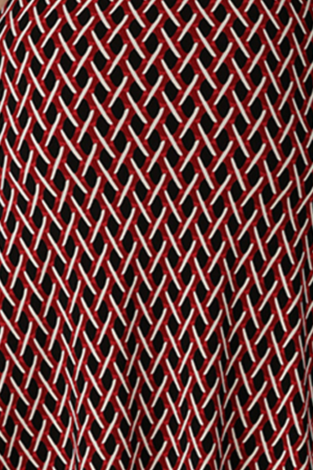 A swatch of red, vanilla and black 'Chevron' print fabric used by Australian fashion brand, Leina & Fleur to make a graphic print dress for work.