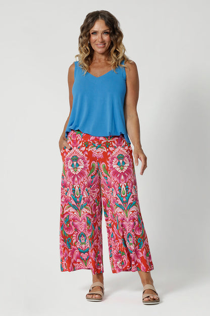 Bamboo summer cami is a perfect blend of elegance and functionality, crafted from luxurious, high-quality bamboo fabric in a serene opal colour. Its sleek, sleeveless design makes it an ideal choice for warm weather, offering a breezy and flattering fit. Model pairs bright cami with printed pants for a summer ready outfit. 
