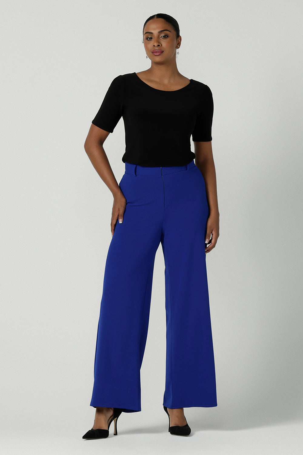 The Drew Pant in Cobalt Scuba Crepe with a wide leg Cobalt pant with a high waist that can be worn with the matching Blazer. Comfortable and easy care suit set for women. Size 8-24. Styled back a black fitted round neckline top. 