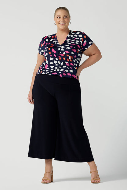 Pictured on curvy size 18 woman wearing business casual wear for women.  Worn with an Emily top in Pink Mariposa animal print. The Dany Culotte is Australian made in a comfortable navy jersey fabric. Wide leg culottes for petite to plus size women 8-24.