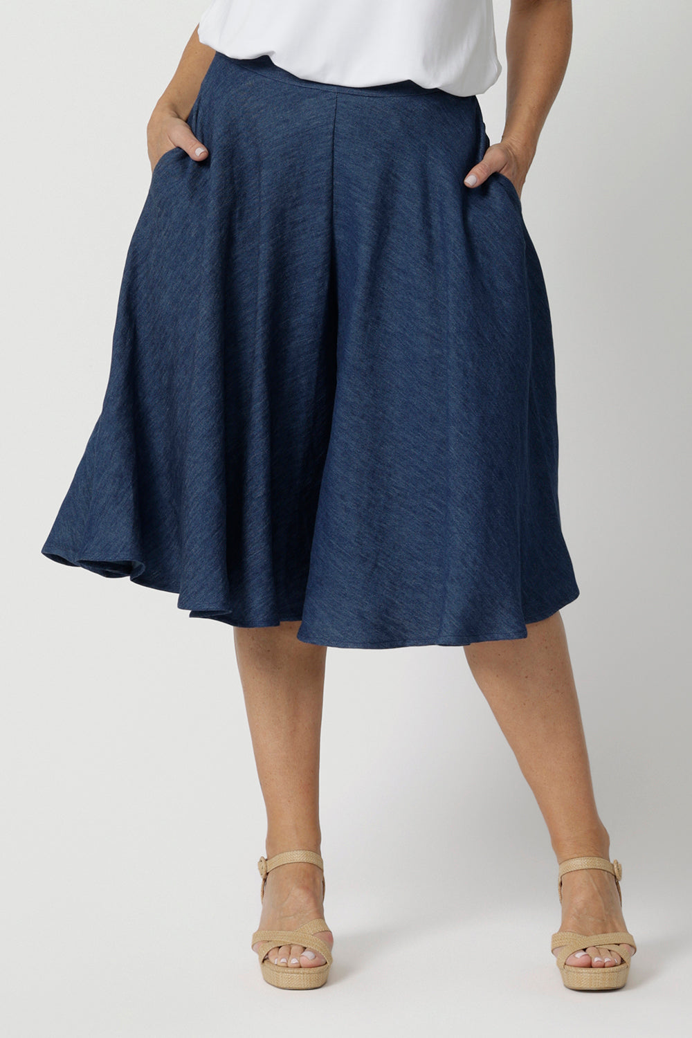 Close up image of denim culotte garment on model showcasing the length and movement that the culotte gives. Fabric used is easy care vintage denim. Breathable and lightweight. Garment from Australian fashion brand Leina & Fleur. Created for women in Australia and New Zealand. 