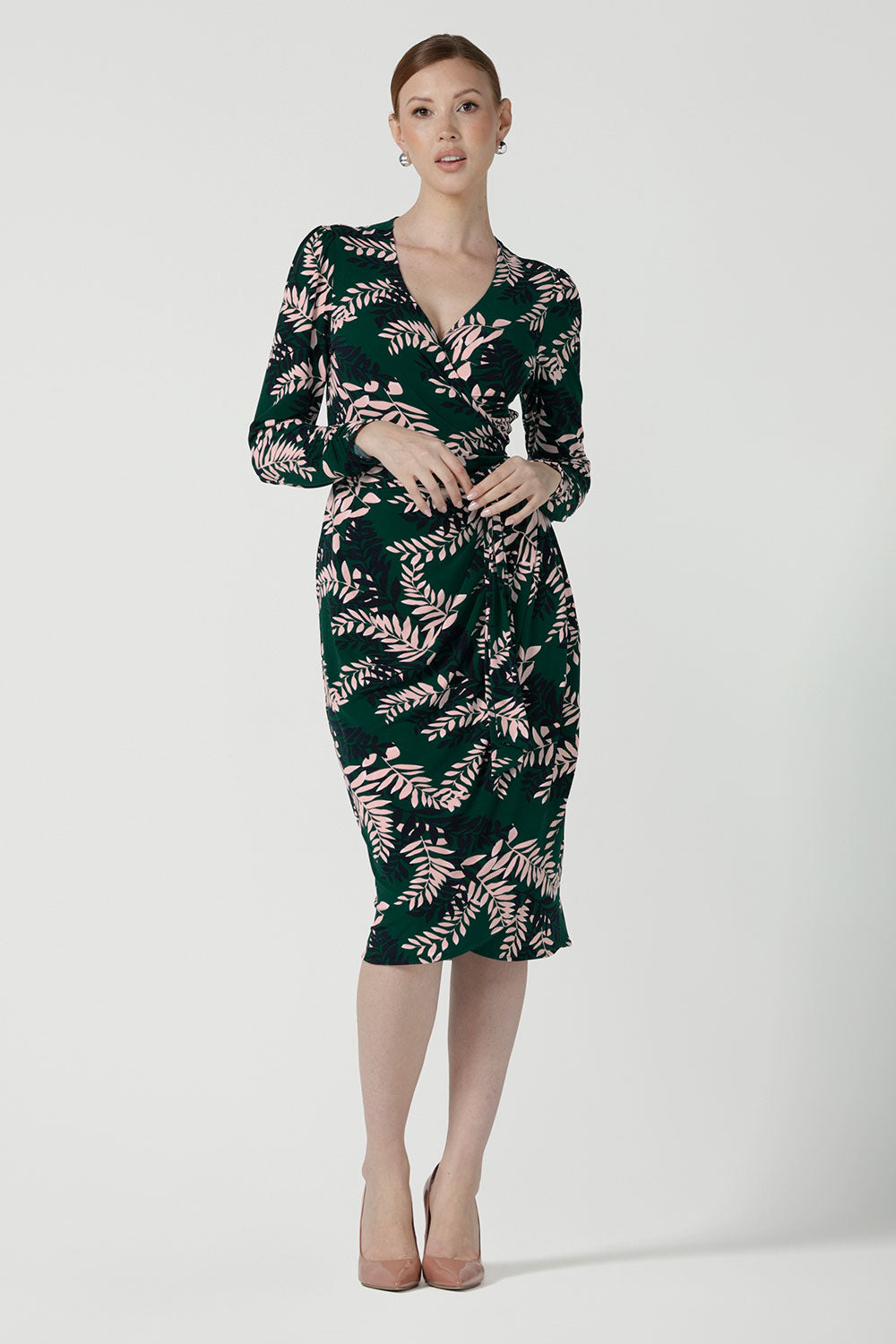 A size 10 model wears the Alpine Fern Heather dress in jersey. Made in Australia for women size 8 - 24. Fern green with leaf print all over.