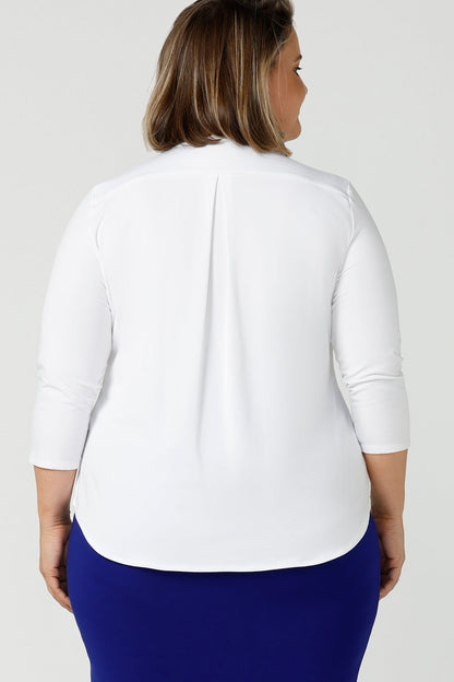 Back view of a good white top for your capsule wardrobe, this V-neck , 3/4 sleeve, white bamboo jersey top has a shoulder yoke and back pleat.  Shown on a size 18, plus size woman, this classic top makes a great work blouse. Made in Australia by Australian andNew Zealand women's clothing brand, Leina & Fleur, this white jersey top is available to shop online in sizes 8 to 24