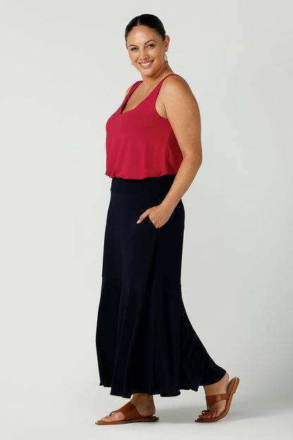 A size 12 happy woman wears a bamboo cami top in red. Bamboo material is breathable and temperature regulating. A great work to weekend top for the Christmas season. Styled back with a Navy Maxi skirt in soft jersey. Made in Australia for women size 8 - 24.