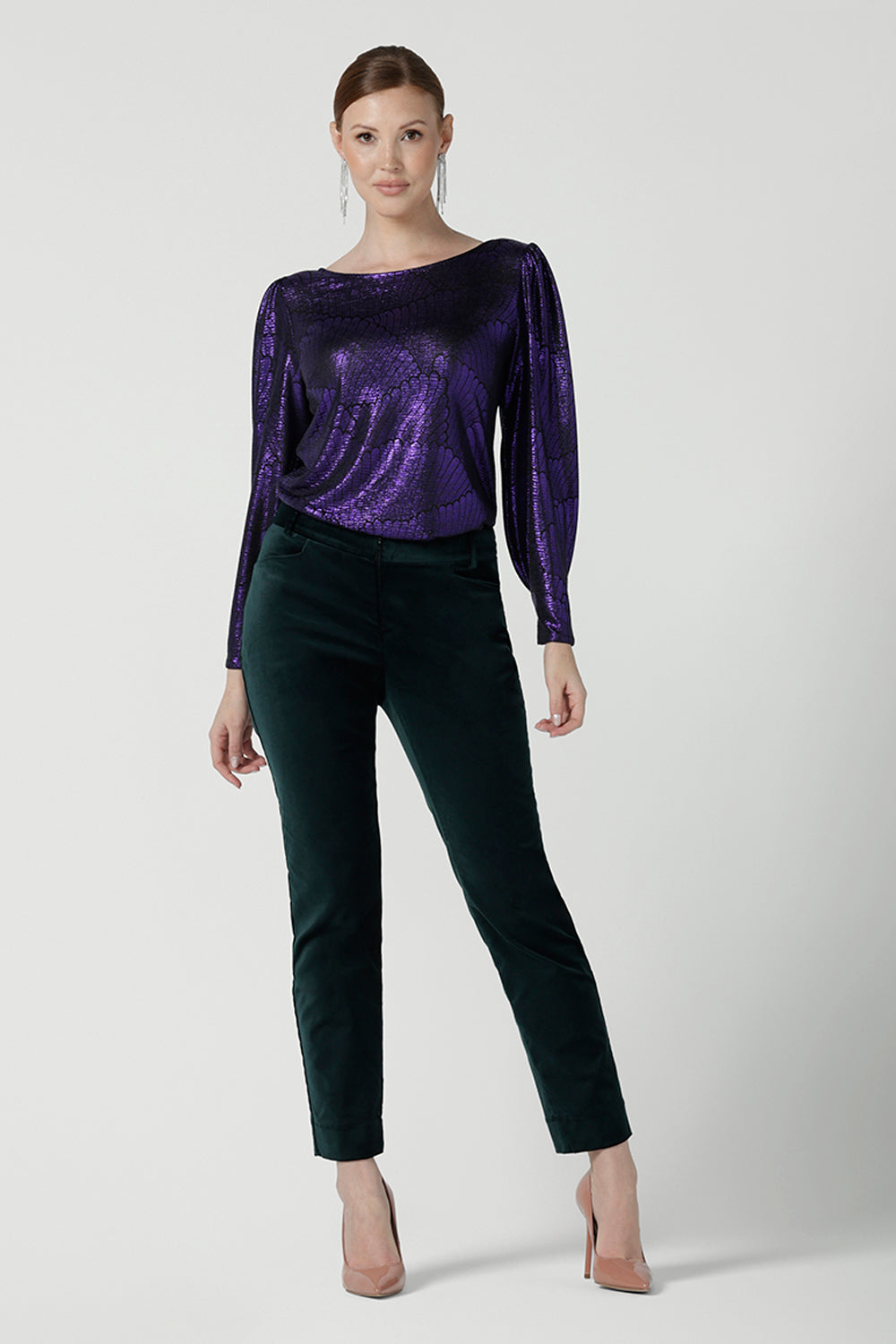 Front view of a size 10 woman wearing the Jonas Pant in green velveteen. A made in Australia velveteen pant styled back with the Purple Mikado top. 