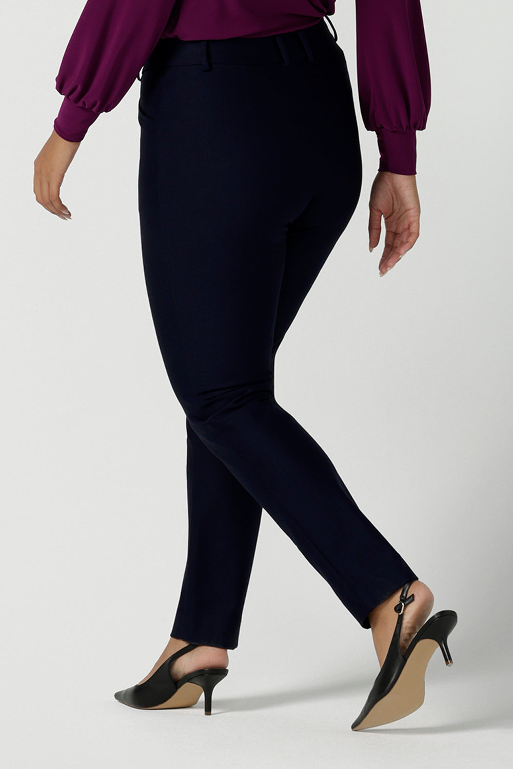 Lulu tailored pant in Navy. Made in Australia for women size 8 - 24. Made in Australia for women size 8 - 24. A tailored pant in Navy with waistband and fly front with pockets. Styled back with the Avery top in Magenta. Size 8 - 24 .