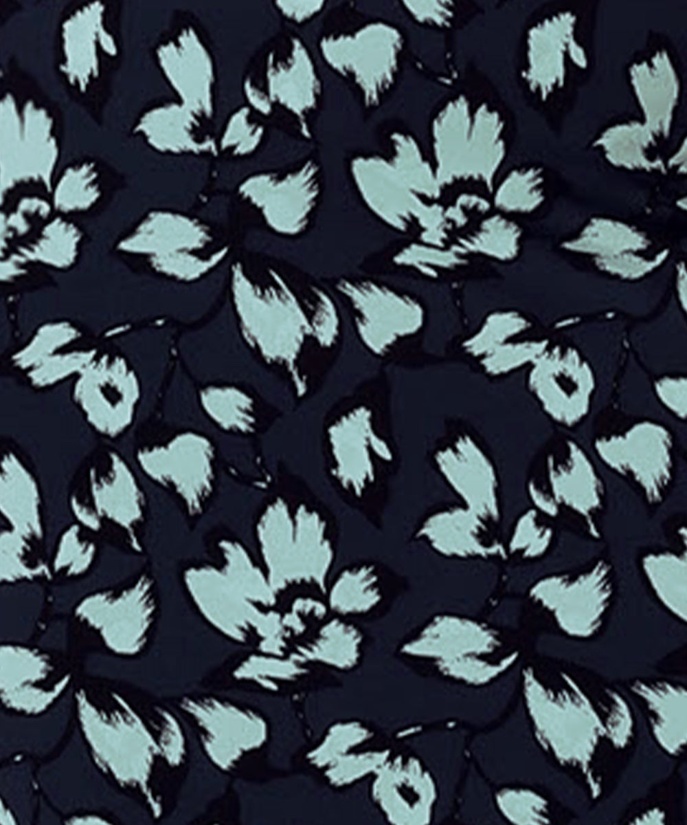 Image shows a swatch of aqua blue floral print on navy blue dry touch jersey fabric, used by Australia and New Zealand women's fashion brand, Leina & Fleur to make a collection of wrap dresses and workwear tops.