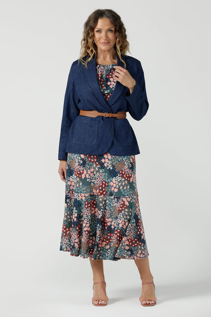 Worn on one shoulder. A woman wears the Myla dress in Whimsy an off shoulder frill neck style. Side pockets and frill hem. Made in Australia and size inclusive for women size 8-24. Styled back with a Denim Blazer.
