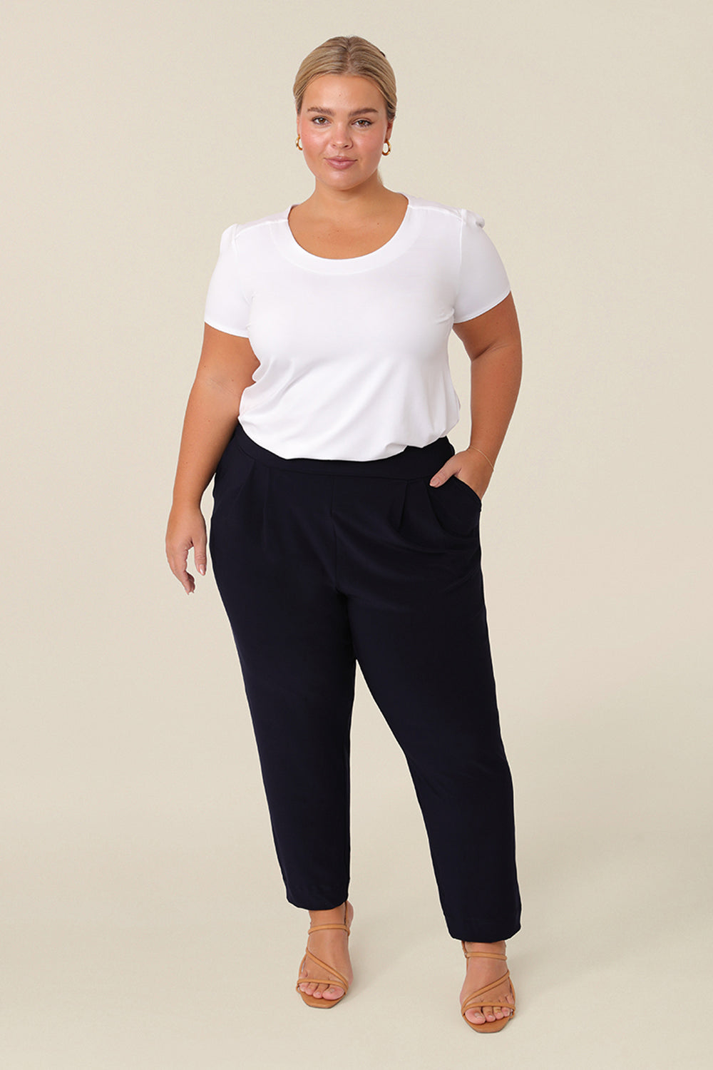 Great pants for travelling, these dropped crotch, trousers with cropped, tapered legs are show for petite height women. Worn with a white bamboo jersey, short sleeve top, these stretchy navy jersey, pull-on trousers are comfortable travel pants that wear well as weekend and casual pants too.