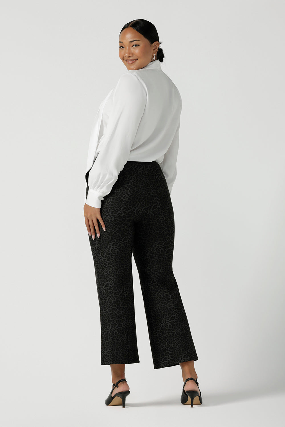 Back view of a stylish woman wears Grey Leopard printed Ponte Troy Pants. A kick flare pant in a fashionable on trend leopard print paired back with a Matisse shirt in white. Made in Australia for women size 8 - 24.