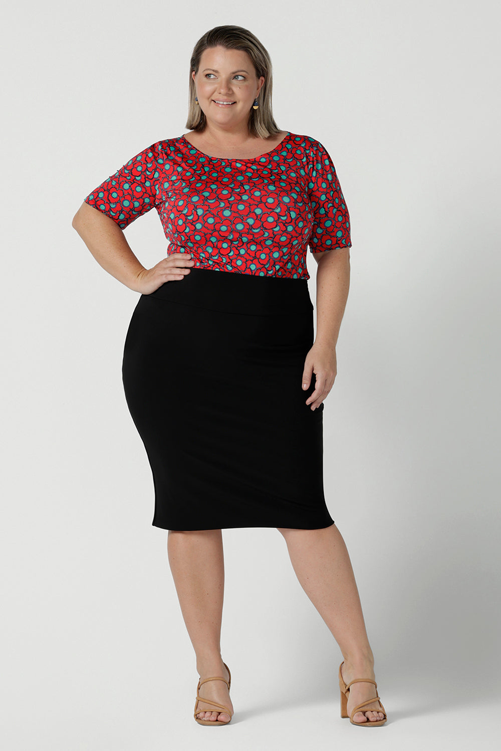 Size 12 woman wears the Ziggy top in Rio with a red base and seventies style floral. Round and conservative neckline. Short sleeve and made in Australia for women size 8 - 24.