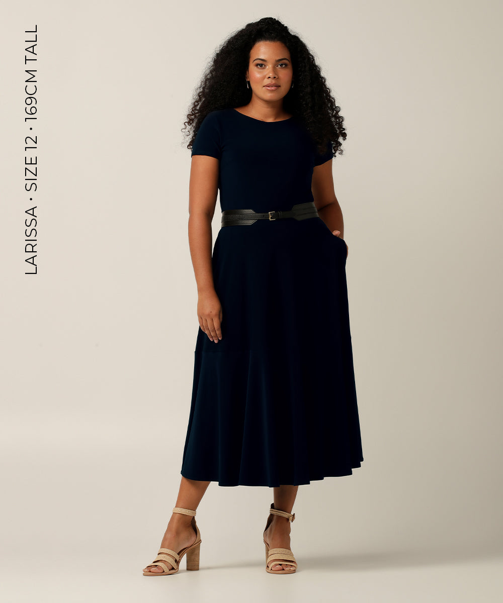 The black leather-look belt featured here is designed to fit comfortably at the waist, with a stretchy back that can accommodate a range of body shapes. It is available in nine different sizes for the perfect fit.  The model in the accompanying photo is wearing a black mid-length dress to showcase the belt's versatility and ability to add a touch of elegance to any outfit.
