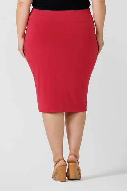 Close up back view of a curvy size 18 woman wears a fuchsia Andi tube skirt. A comfortable workwear piece from desk to dinner. Made in Australia for women sizes 8 - 24.