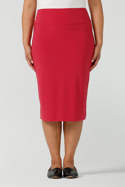 Close up of a fuchsia pink skirt knee length styled with black flat shoes for a corporate office environment. Made in Australia for women size 8 - 24. 