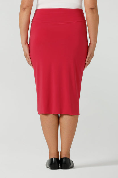 Back view of a close up of a fuchsia pink skirt knee length styled with black flat shoes for a corporate office environment. Made in Australia for women size 8 - 24.