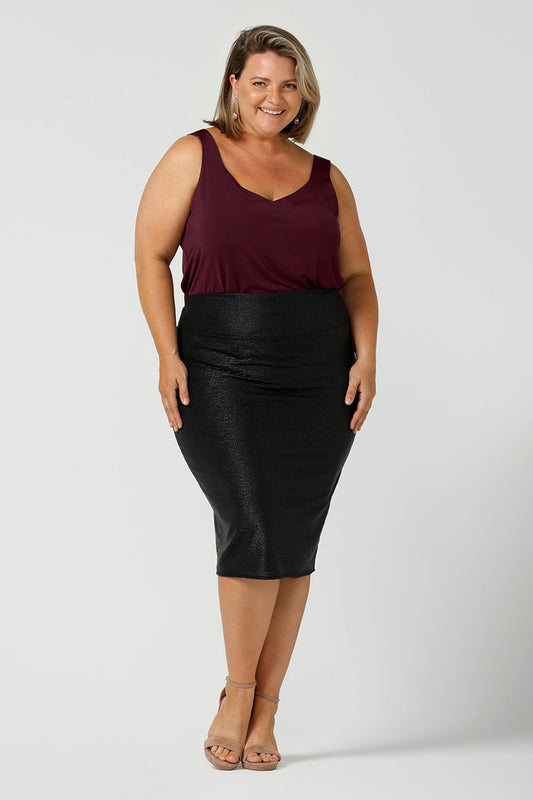 A glitzy skirt for cocktail and event wear, the Brooke Tube Skirt by Australian and New Zealand womenswear brand, L&F glitters in black shimmer jersey. A pull-on pencil skirt, the Brooke Tube Skirt's stretchy fabric makes for a comfortable evening-wear outfit, as shown here worn with a plum, slinky jersey camisole top. Shop this cocktail dress look in sizes 8 to 24.