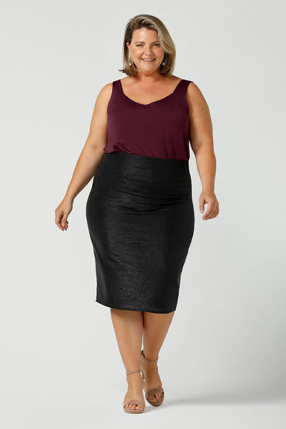 A glitzy skirt for cocktail and event wear, the Brooke Tube Skirt by Australian and New Zealand womenswear brand, L&F glitters in black shimmer jersey. A pull-on pencil skirt, the Brooke Tube Skirt's stretchy fabric makes for a comfortable evening-wear outfit, as shown here worn with a plum, slinky jersey camisole top. Shop this cocktail dress look in sizes 8 to 24.