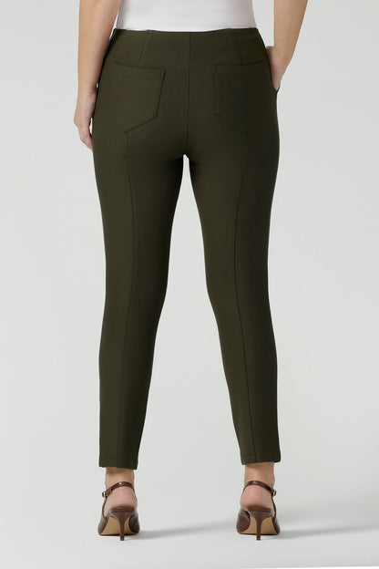 Back view of slim leg, cropped length pants in olive green. Tailored skinny pants with pockets and a front zip fastening these made-in-Australia  work pants fit petite, mid size and plus size women.