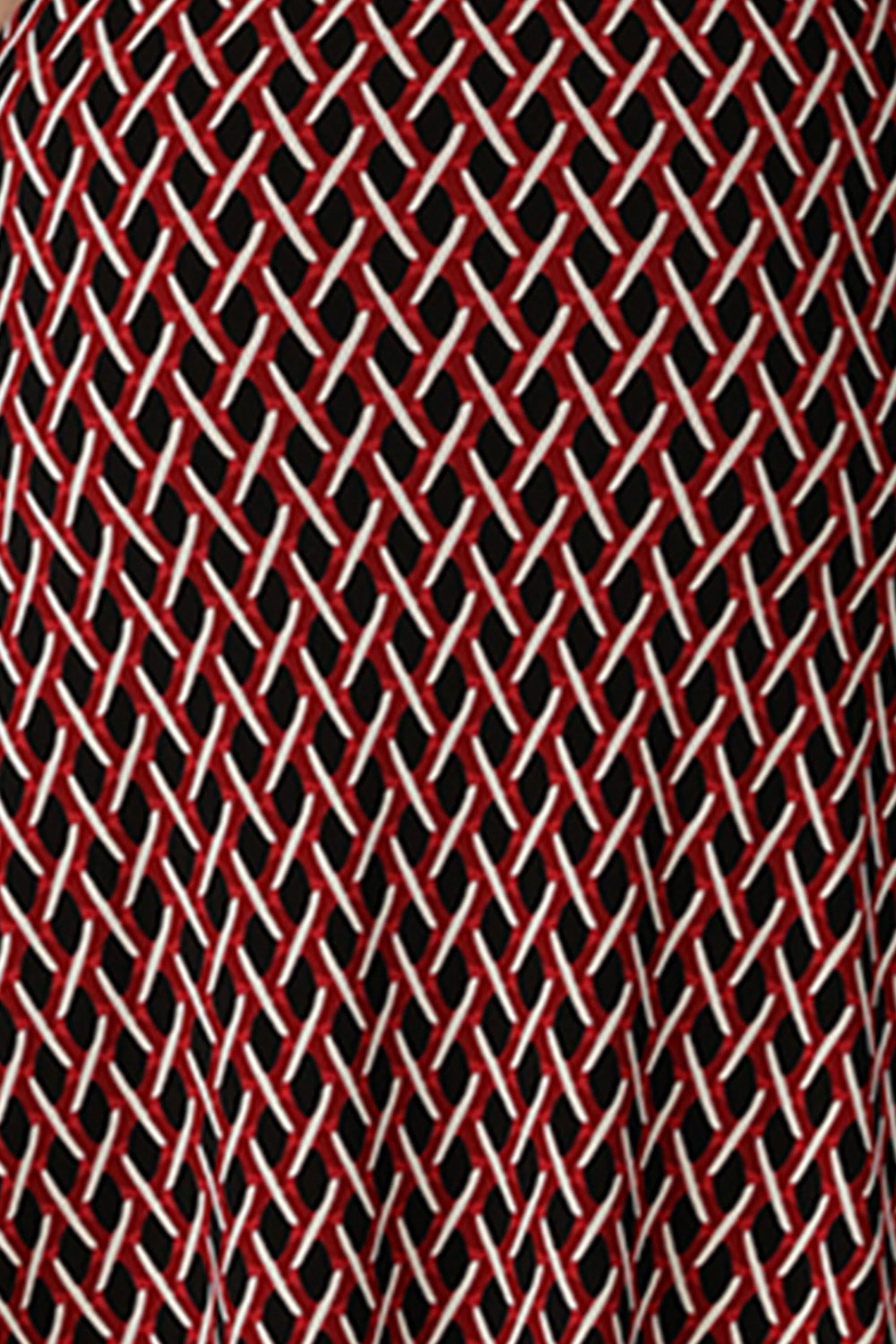 A swatch of red, vanilla and black 'Chevron' print fabric used by Australian fashion brand, Leina & Fleur to make a range of women's workwear printed wide leg pants.