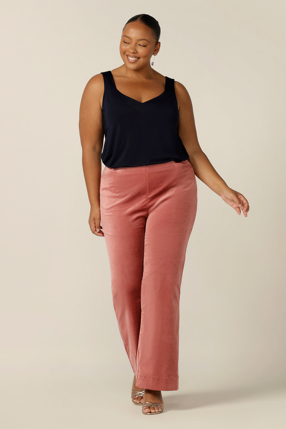 Evening and cocktail wear for plus size women gets a touch of disco fever with these flared leg, tailored pants in musk pink velveteen. Worn with a slinky navy blue cami top for eveningwear, these special event pants are made in Australia in sizes 8 to 24, petite to plus sizes.