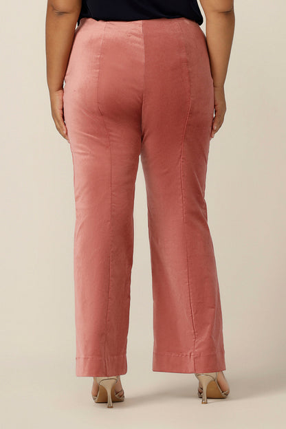 Back view of flared leg, tailored pants in musk pink velveteen. Made in Australia by Australian and New Zealand women's clothing brand, L&F, these special event pants are are available to shop in an inclusive size range of sizes 8 to 24, petite to plus sizes.