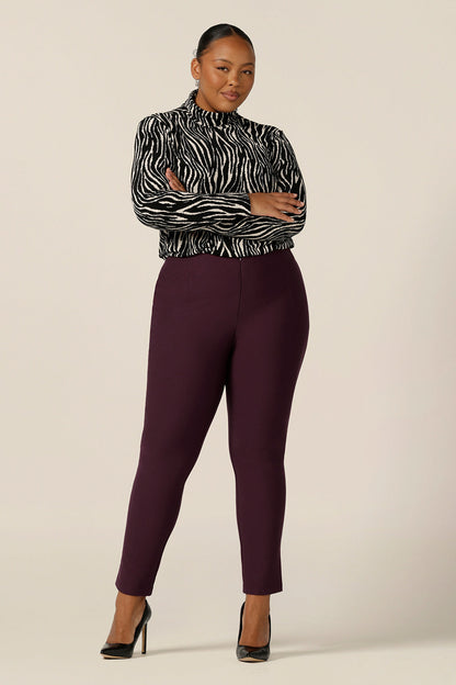 Showcased in a size 18 for plus size women, this long sleeve, turtle neck top is a glamorous top in black and white zebra print stripes. Worn with slim leg, cropped length pants, both are made in Australia by Australian and New Zealand women's clothing brand, L&F, shop this work top in sizes 8 to 24.