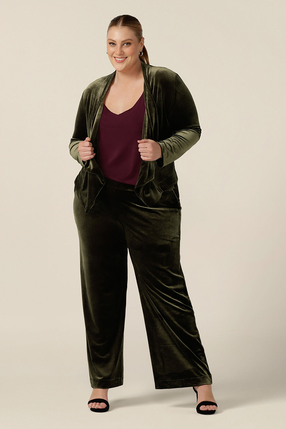 The best cocktail pant suit for plus size women, the Deni Pant and Romy Jacket wear together with a plum cami top for a lougewear tuxedo look. Straight, wide leg pants in green velour, these evening trousers are pull on pants and comfortable in stretch fabric. Shop this occasion and cocktail attire online at Australian fashion brand, Leina & Fleur.