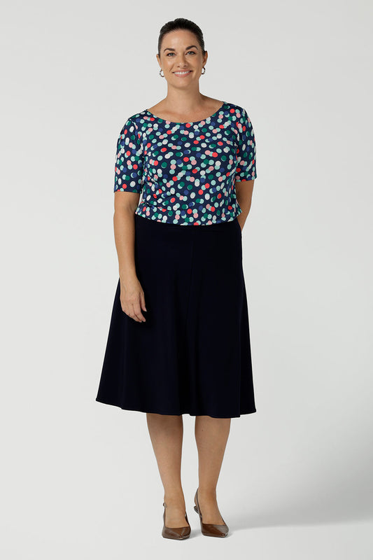 A size 12 woman wears the Cassidy skirt in Navy. A comfortable work wear wear corporate casual skirt. Made in Australia for women size 8 - 24.