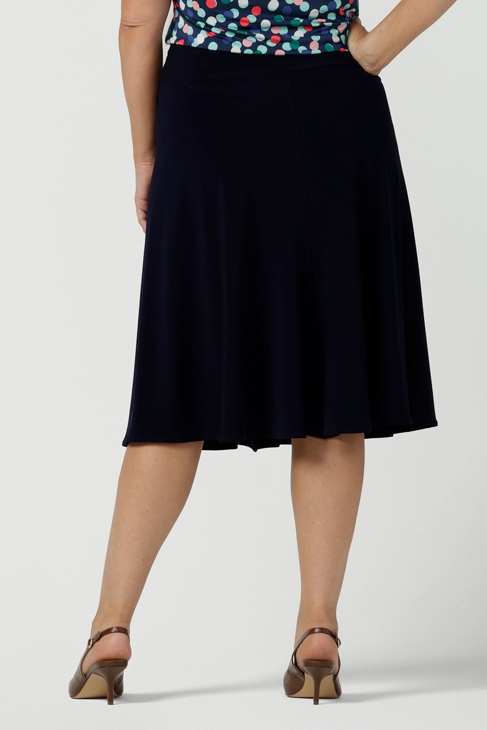 Back view of a size 12 woman wears the Cassidy skirt in Navy. A comfortable work wear wear corporate casual skirt. Made in Australia for women size 8 - 24.